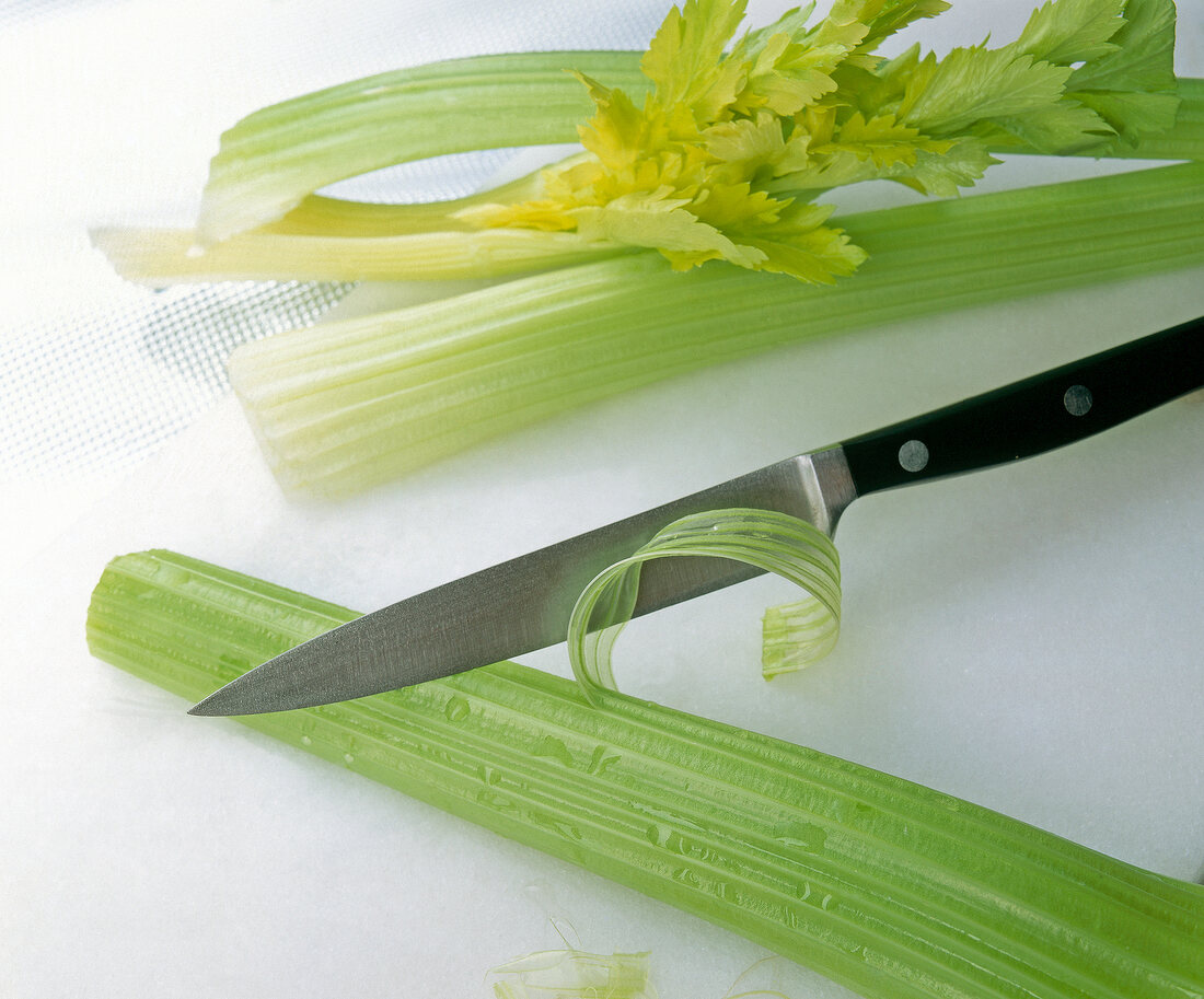 Threads being removed from celery with knife