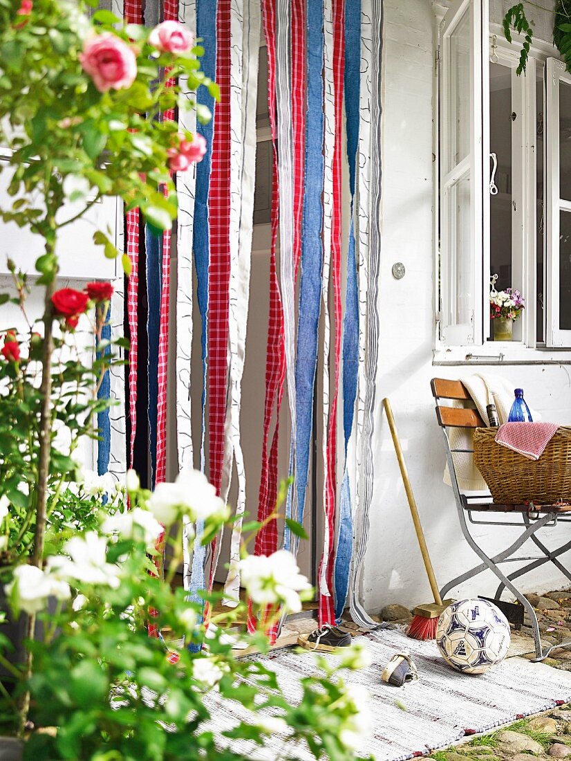 Fly curtain of colourful fabric strips in garden door