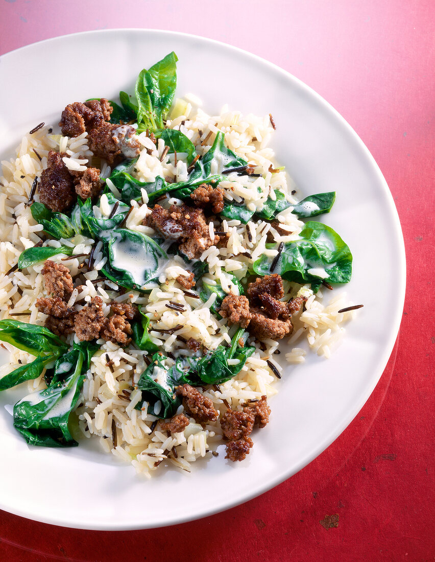Spinach rice with beef and cream sauce in dish