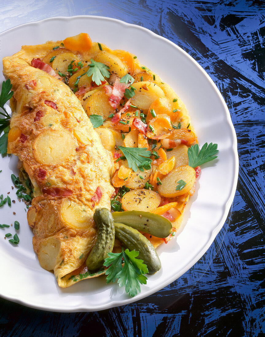 Potato omelettes with vegetables and herbs on plate