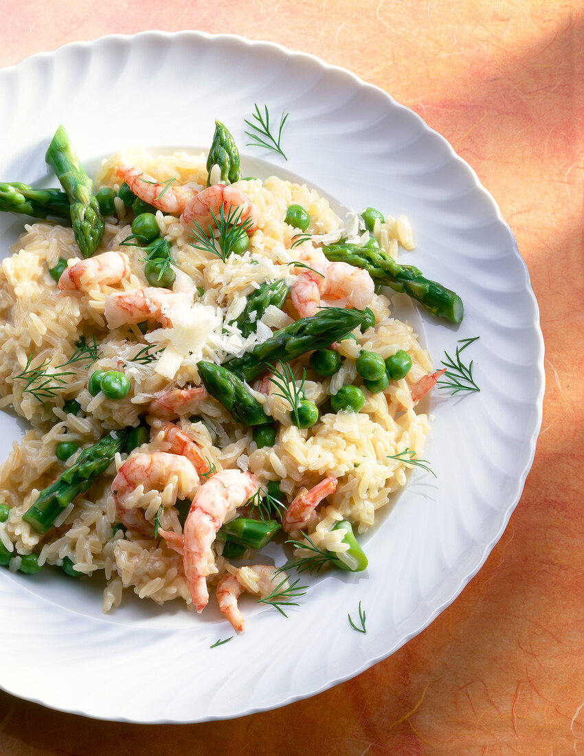 Rice with shrimp and asparagus on plate