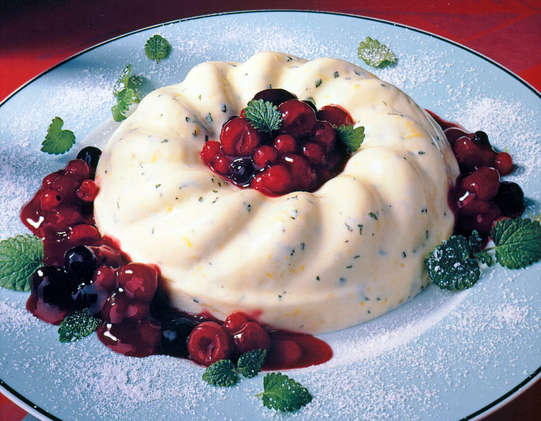 Yogurt cream with lemon and berry compote on plate