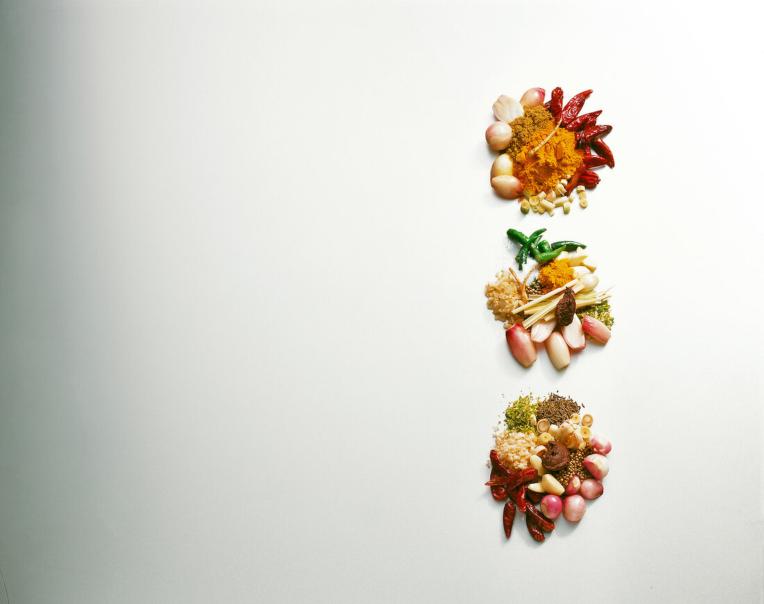 Ingredients for red, green and yellow curry paste on white background