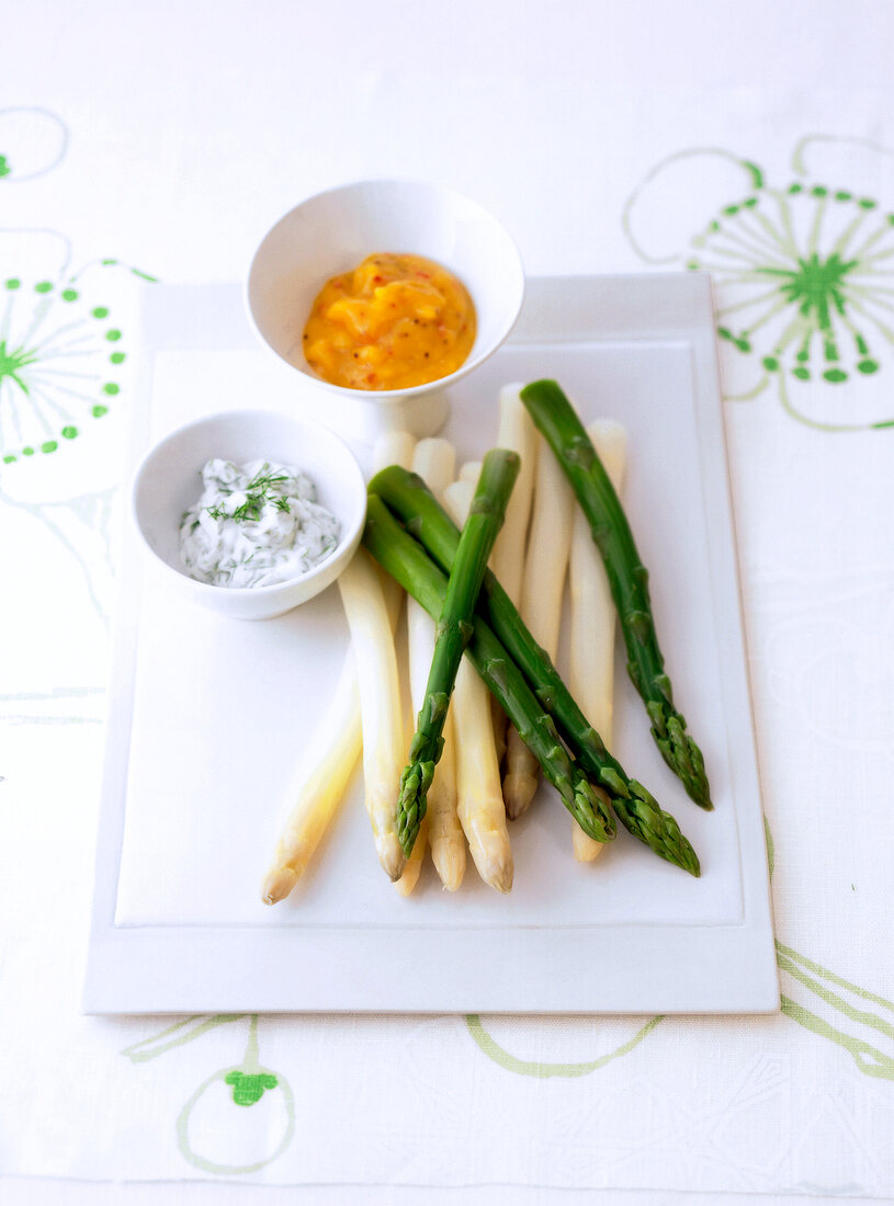 Green and white asparagus served with two sauces