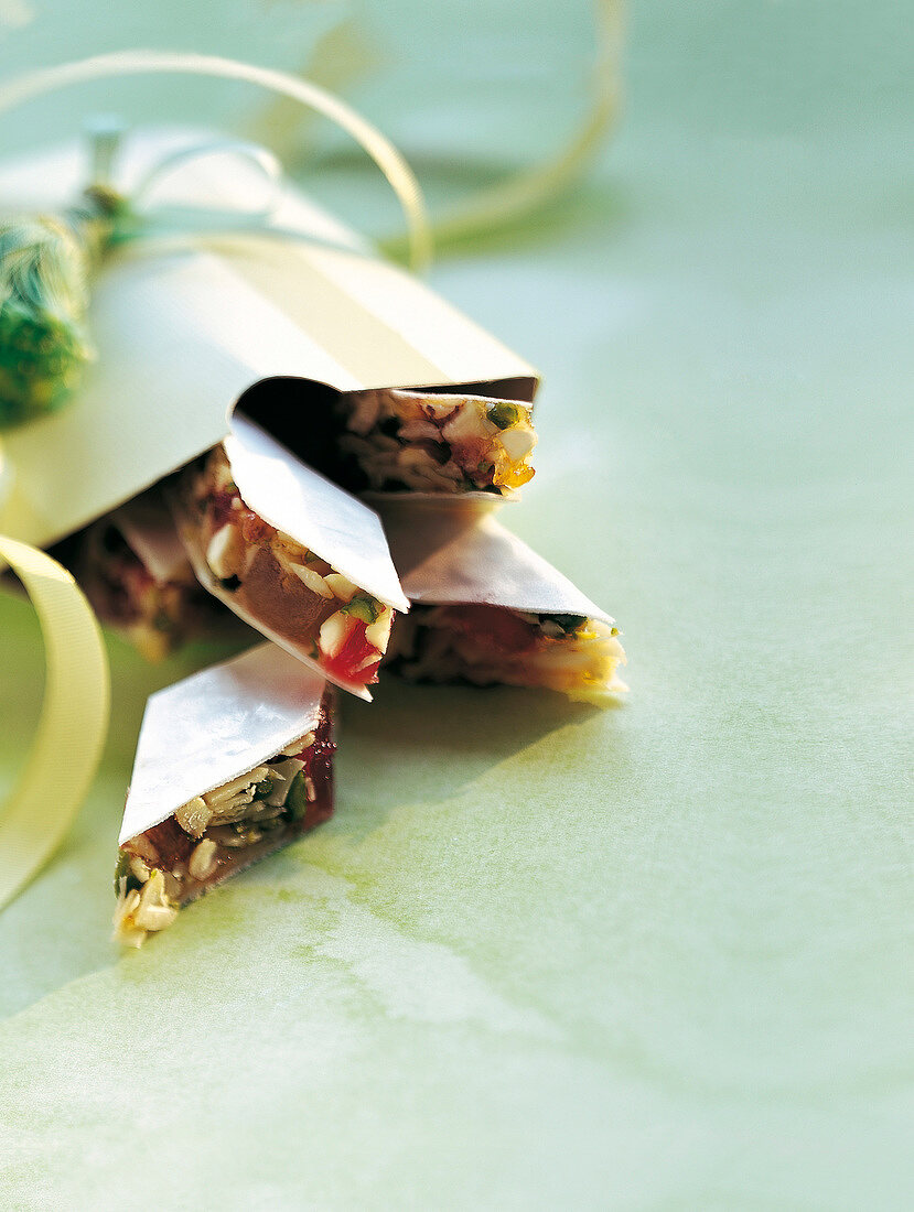 Close-up of crunchy diamond shaped sweets with almonds and pistachios