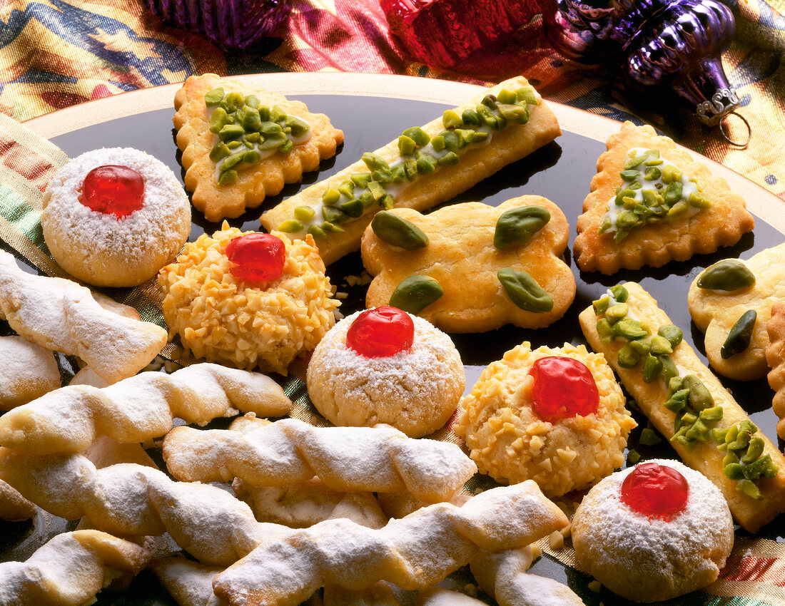 Close-up of Christmas cookies with pistachios and cherries on top