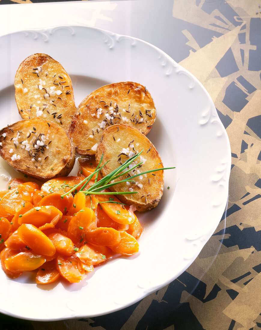 Close-up of caraway potatoes with carrots in dish