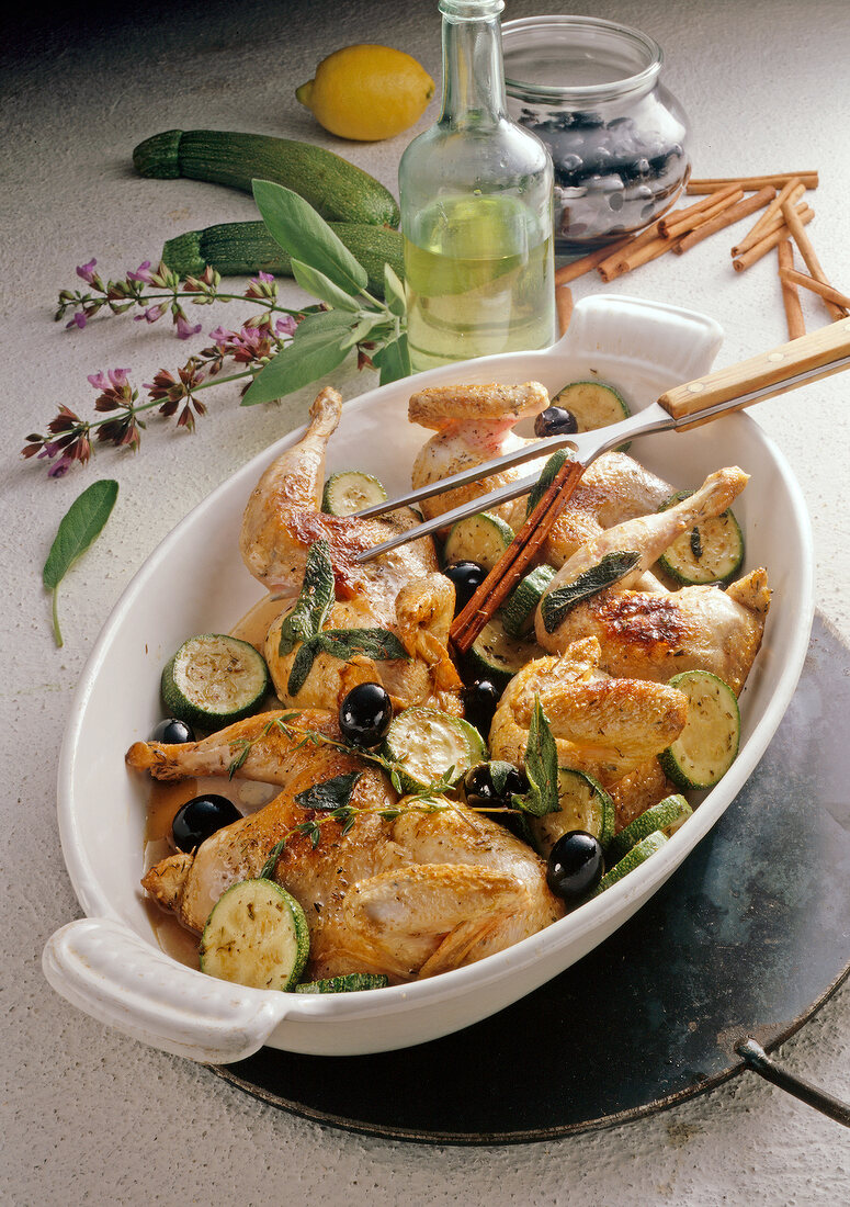 Roasted fowl with zucchini and olives in casserole