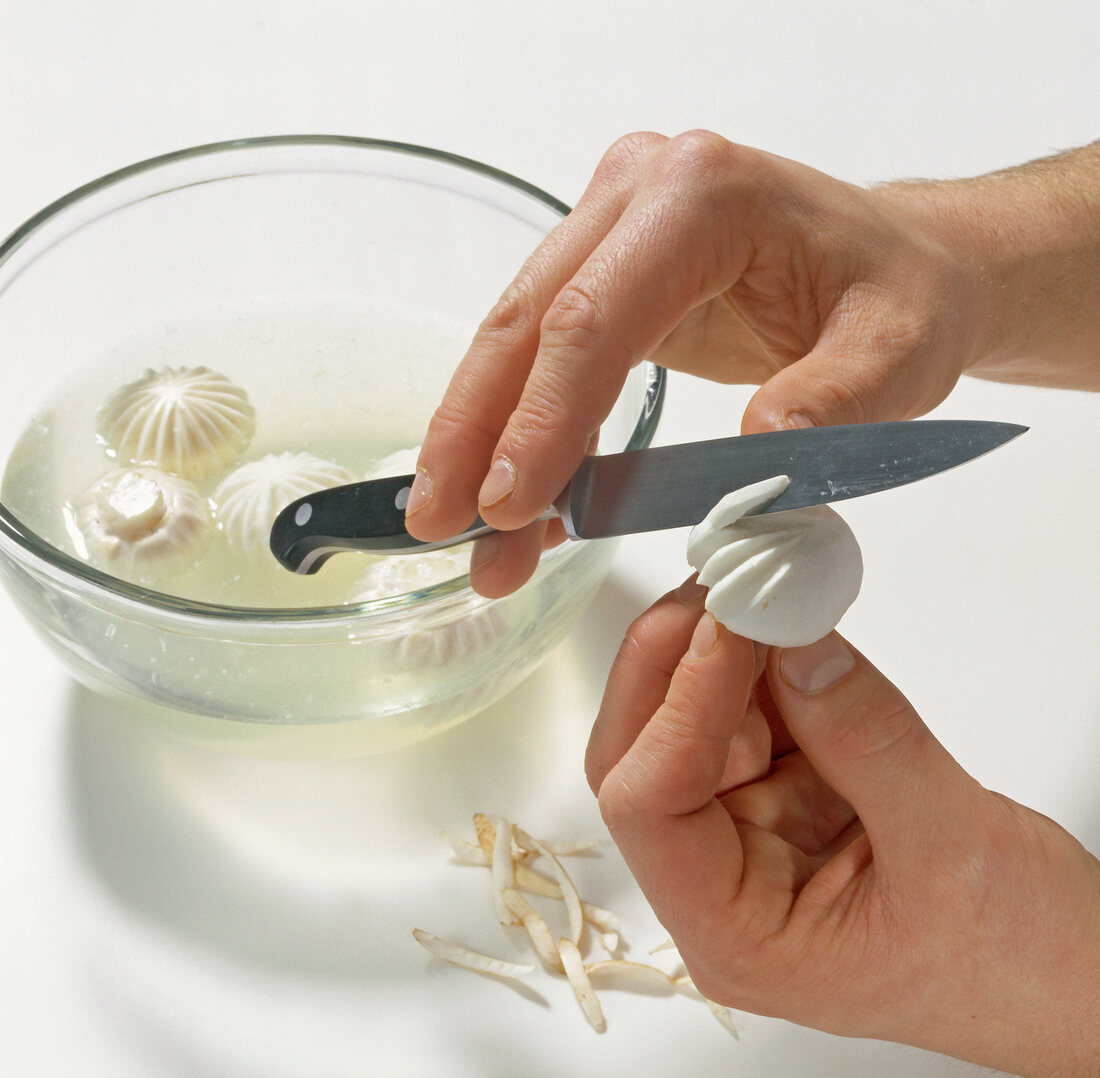 Hand giving shapes to mushrooms, step 2