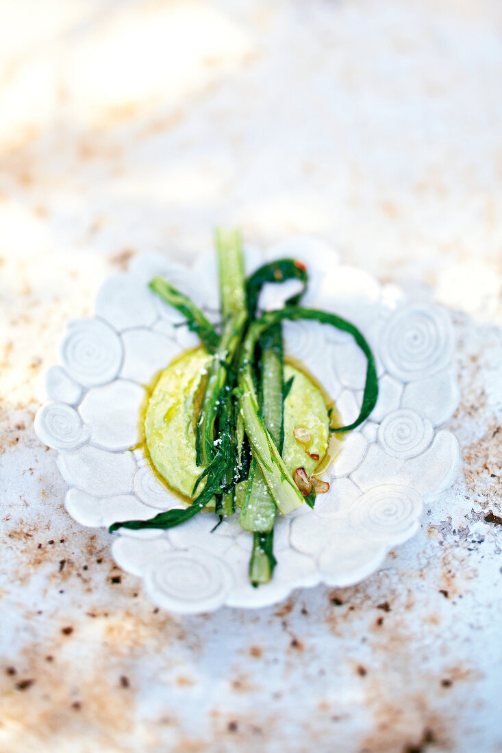 Close-up of beab puree and dandelion leaves in bowl