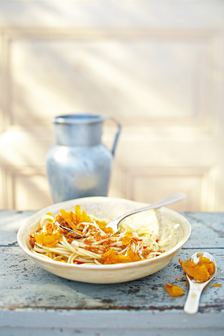 Spaghetti with bottarga, bread crumbs and fork in plate