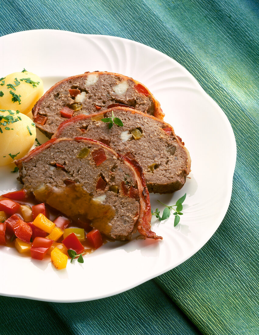 Meatloaf with potatoes and peppers on plate