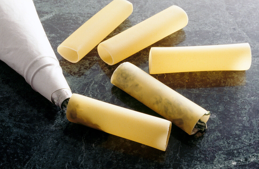 Cannelloni being filled with piping bag