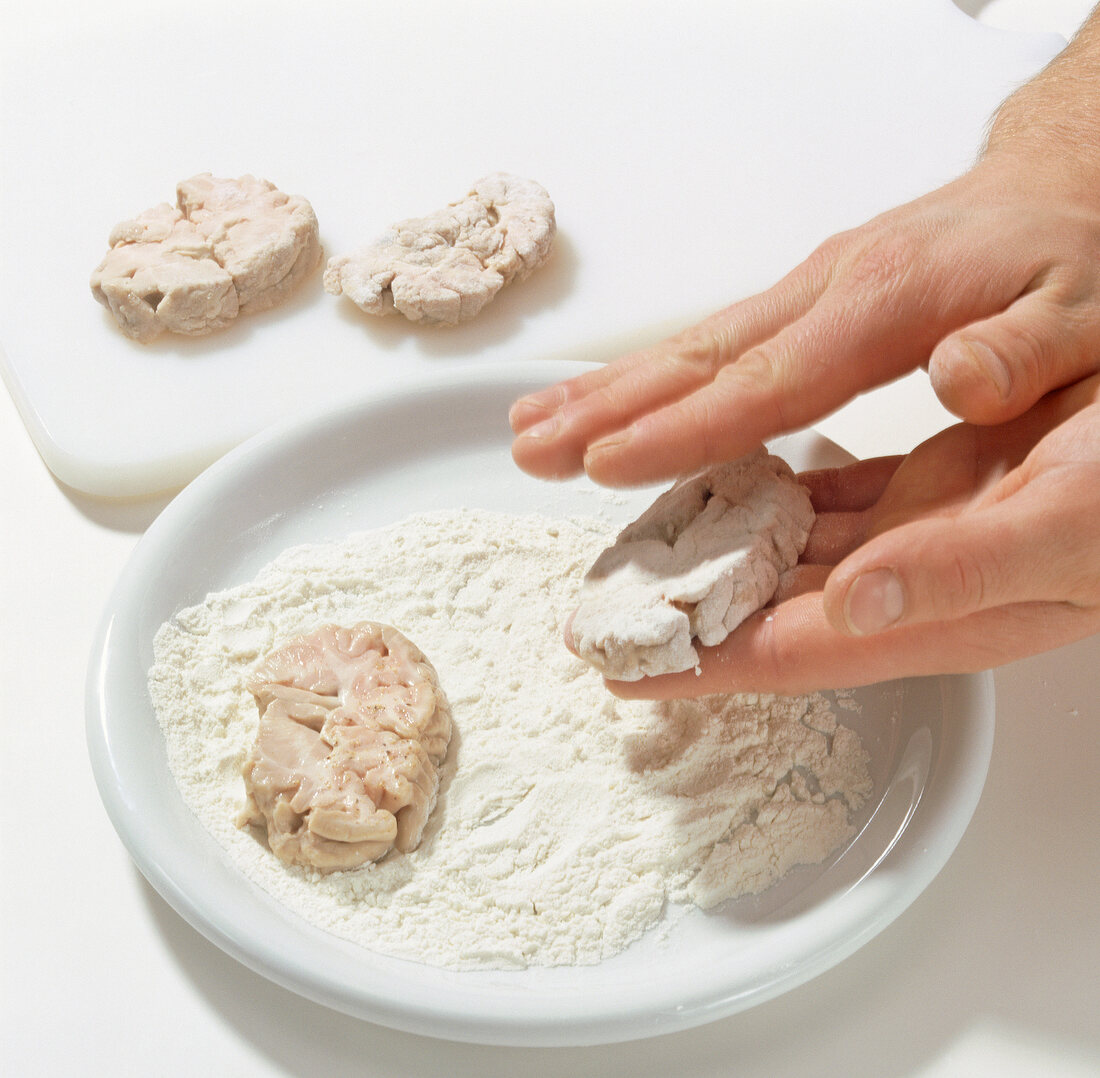 Flour being applied on sliced deer brain, step 5