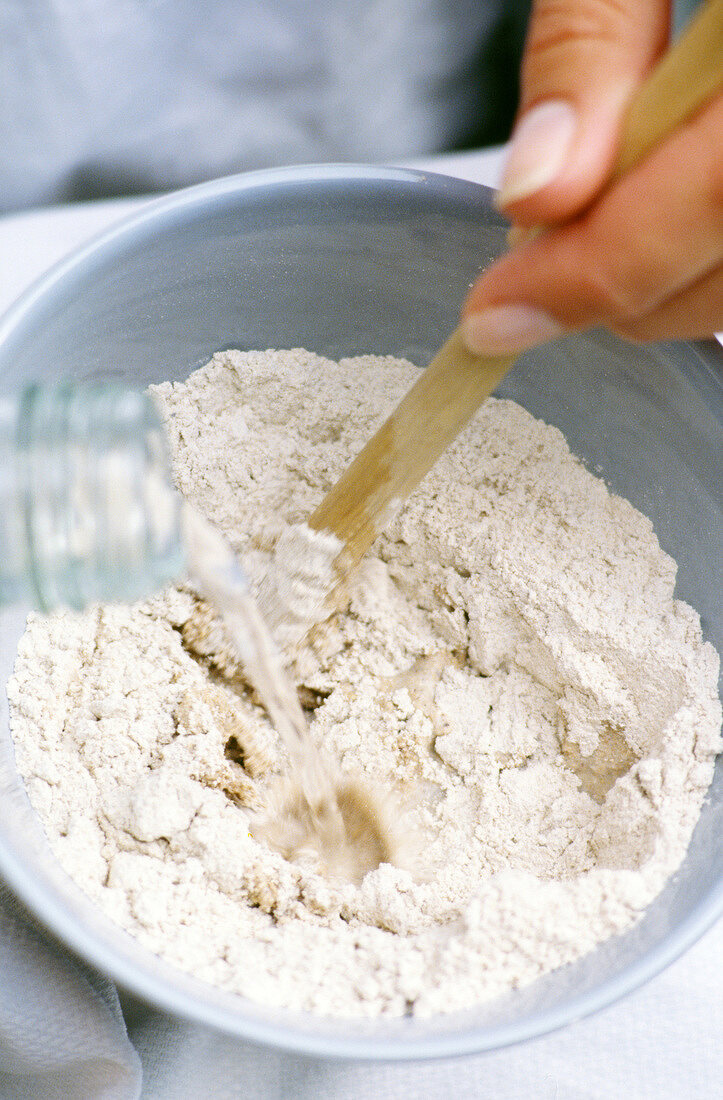 Facial scrub of bran flour being mixed with water