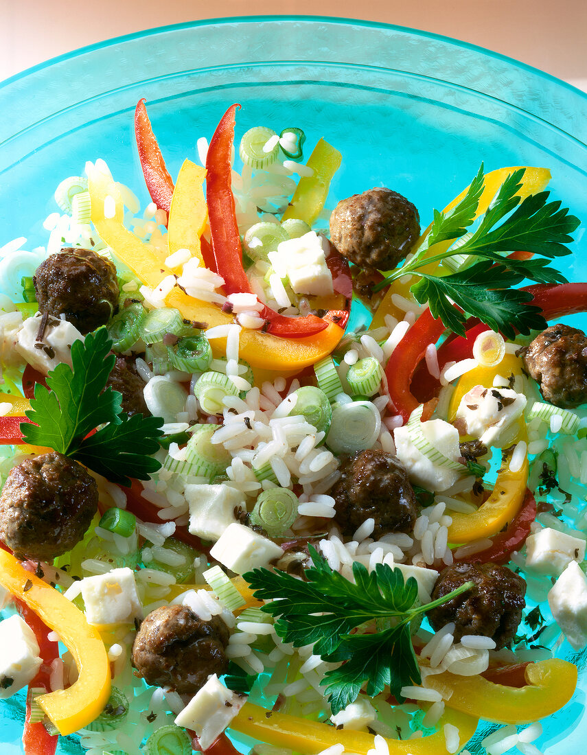 Close-up of pepper salad with meatballs and rice on plate