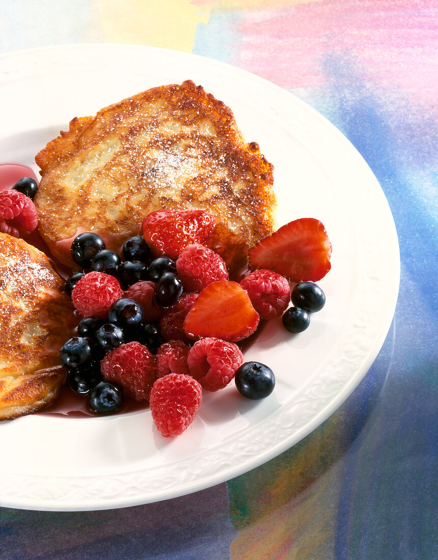 Close-up of quark pancakes with blackberries and raspberries on plate