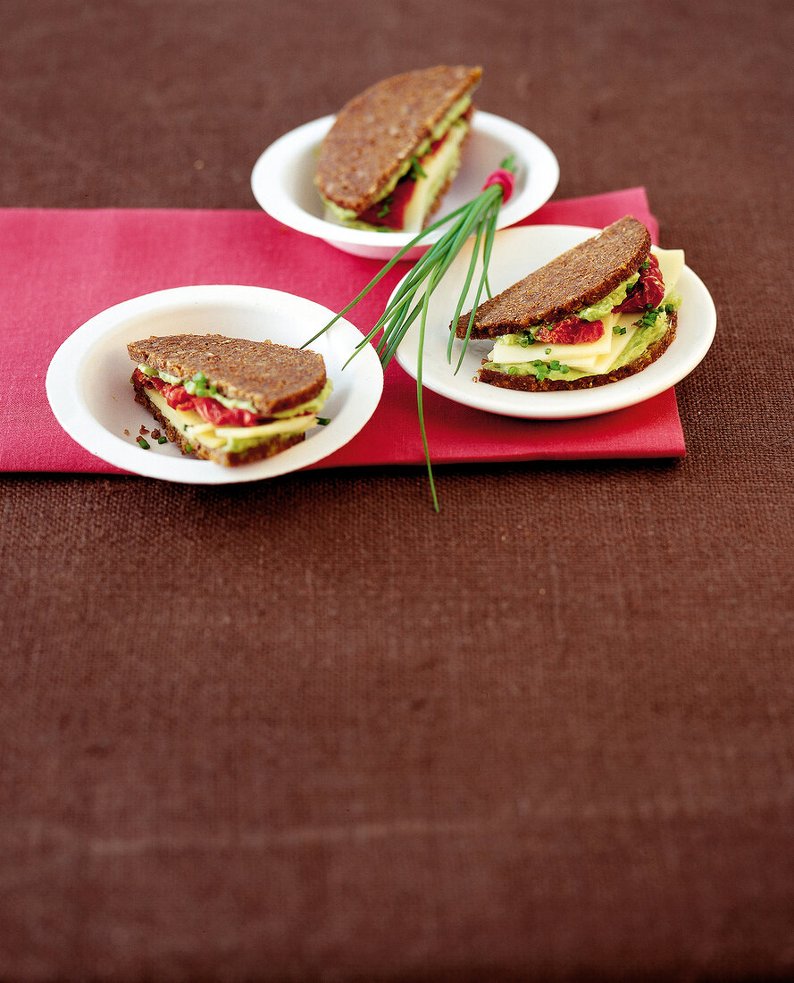 Three cheese sandwiches on napkin