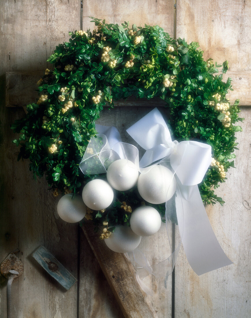 Close-up of Christmas wreath on wooden door