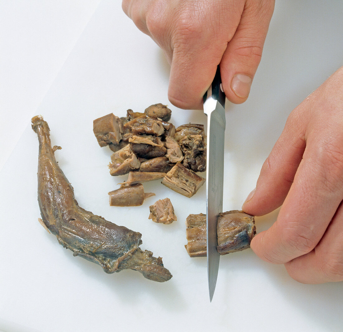 Leg stew being cut on chopping board