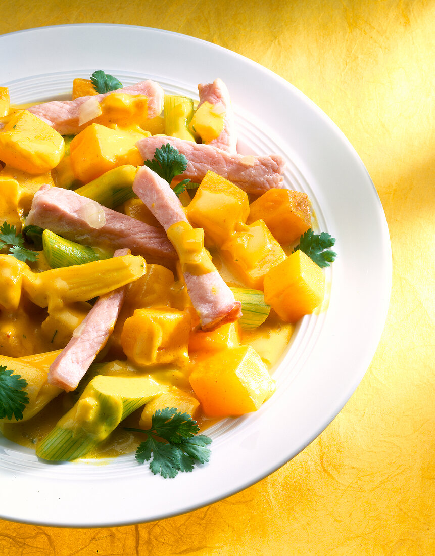 Close-up of pumpkin stew with smoked pork on plate