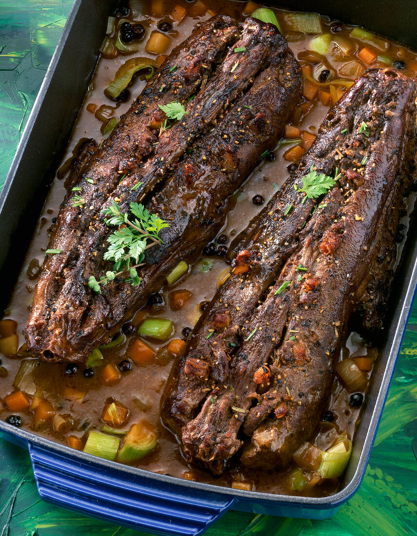 Close-up of hare with juniper sauce in baking dish