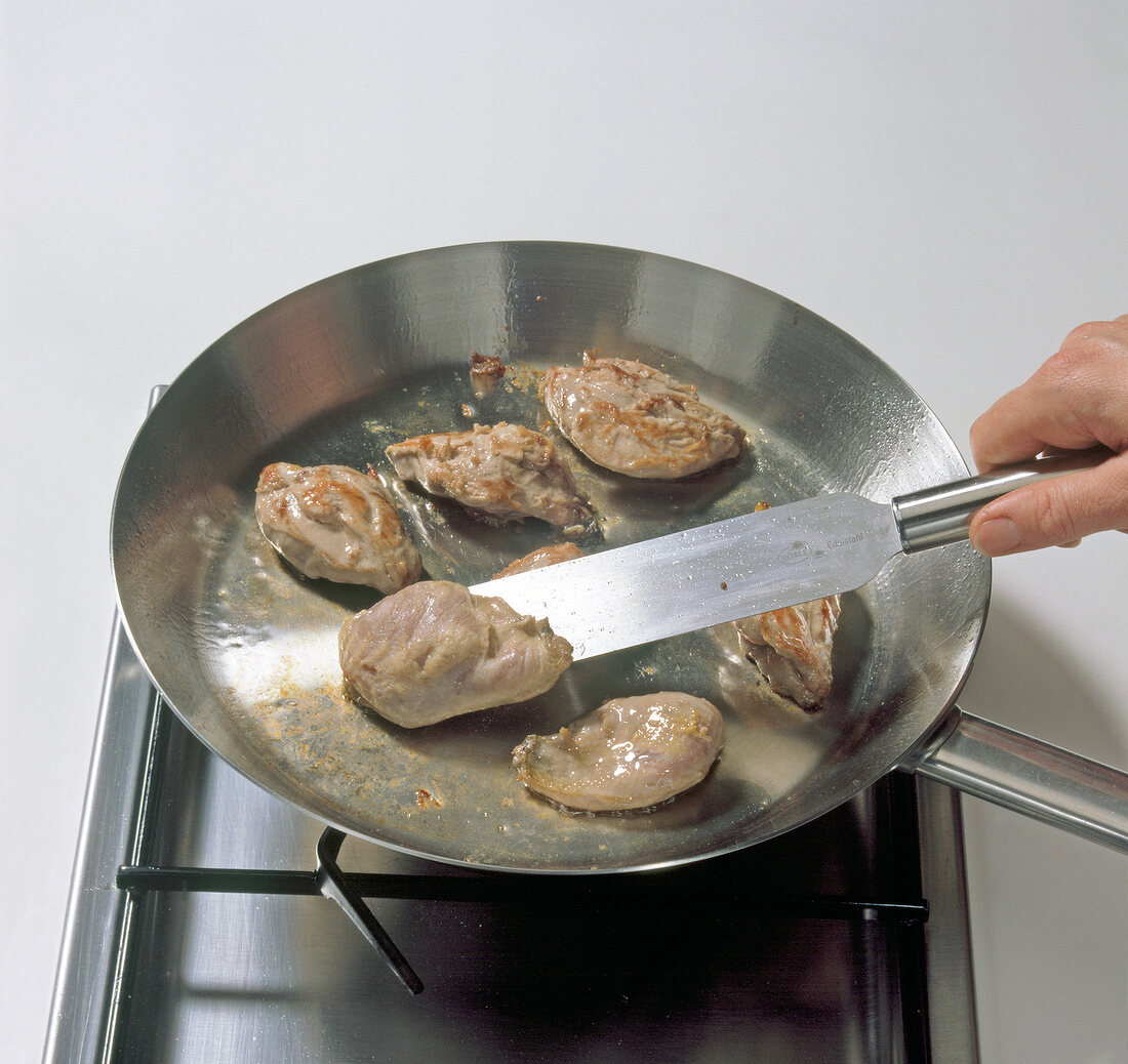 Gray partridge meat being fried in pan for preparation of partridge pie, step 5