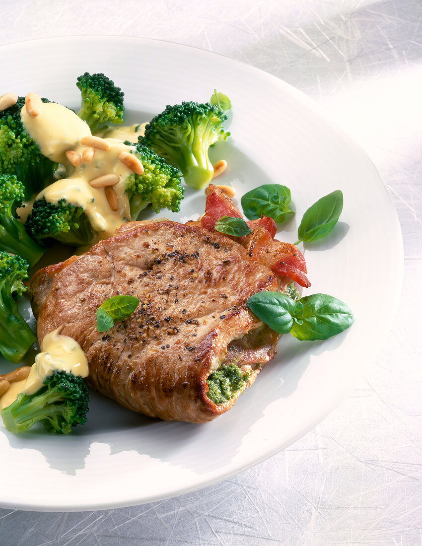 Close-up of stuffed steak with broccoli on plate