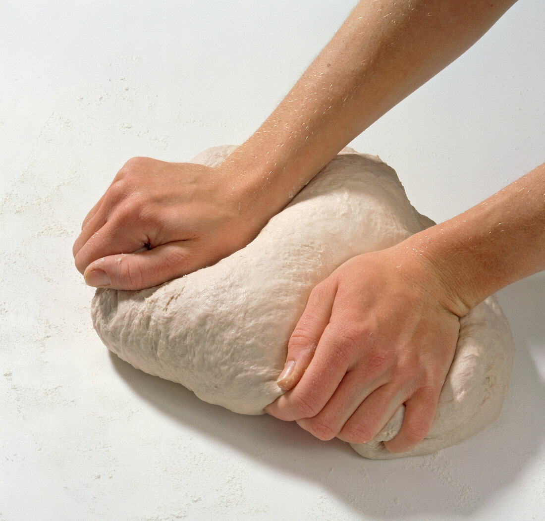 Close-up of kneading dough for preparation of rotwein teig, step 3