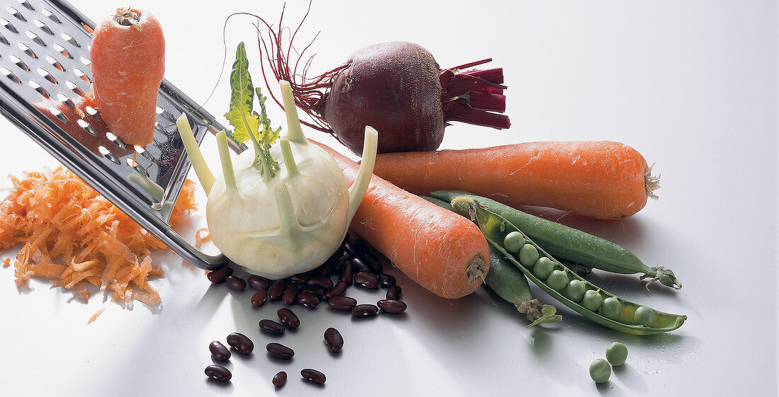 Carrots, turnips, peas, peppers and beetroot on white background