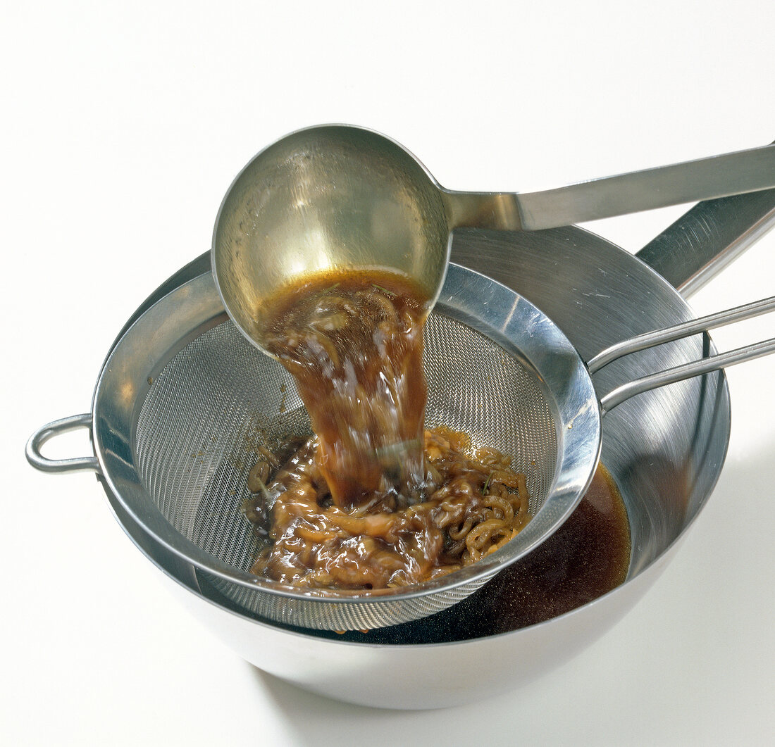 Close-up of sauce being removed through sieve, step 7