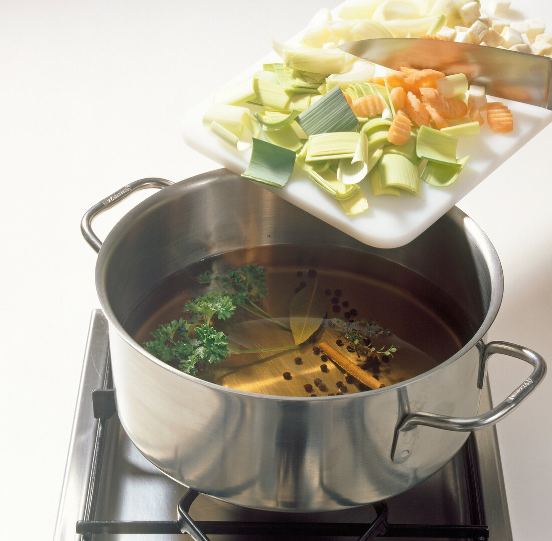 Vegetables being added in pot for preparation of sauerbraten beize, step 1