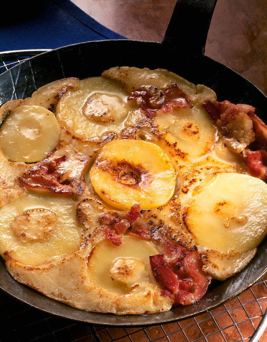 Close-up of apple and bacon pancakes in pan