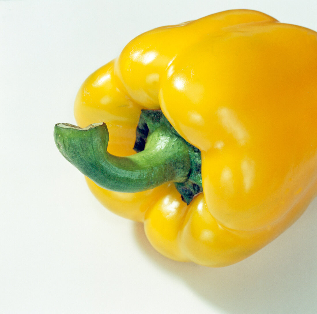 Close-up of yellow pepper on white background, step 1