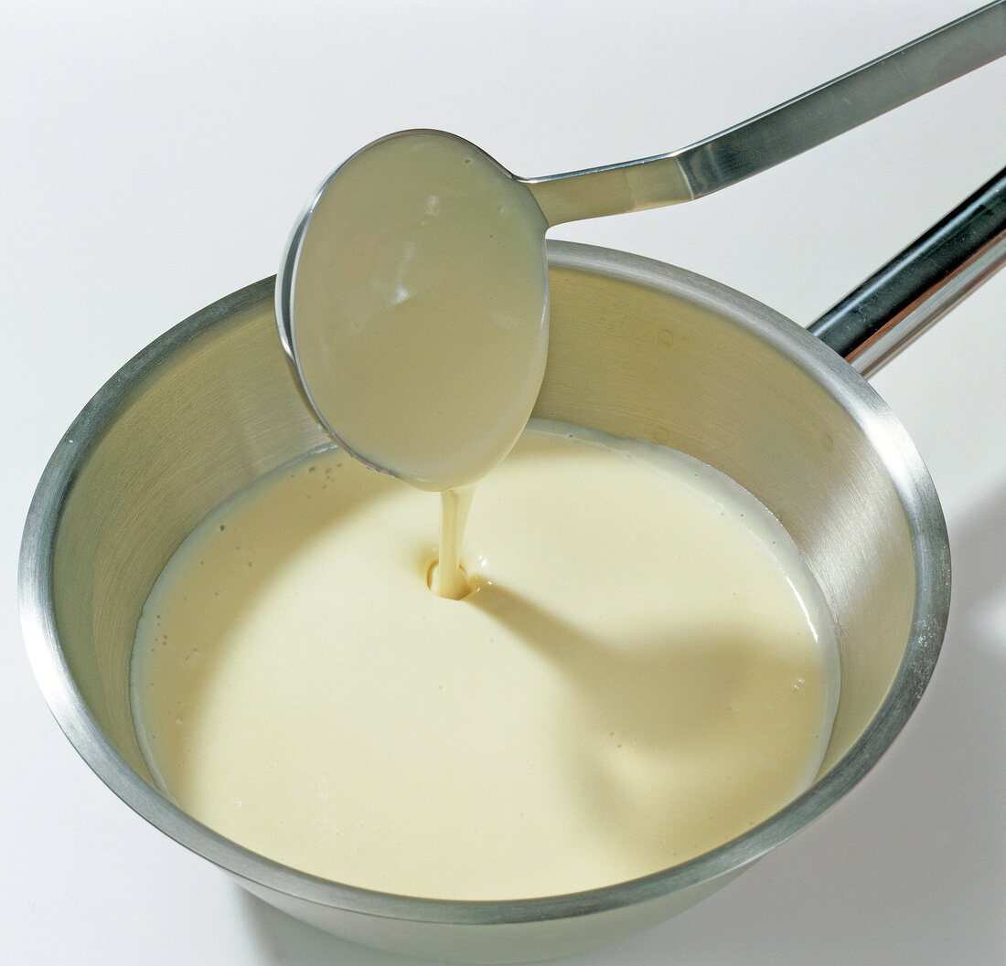 Close-up of sauce being stirred with ladle, step 5