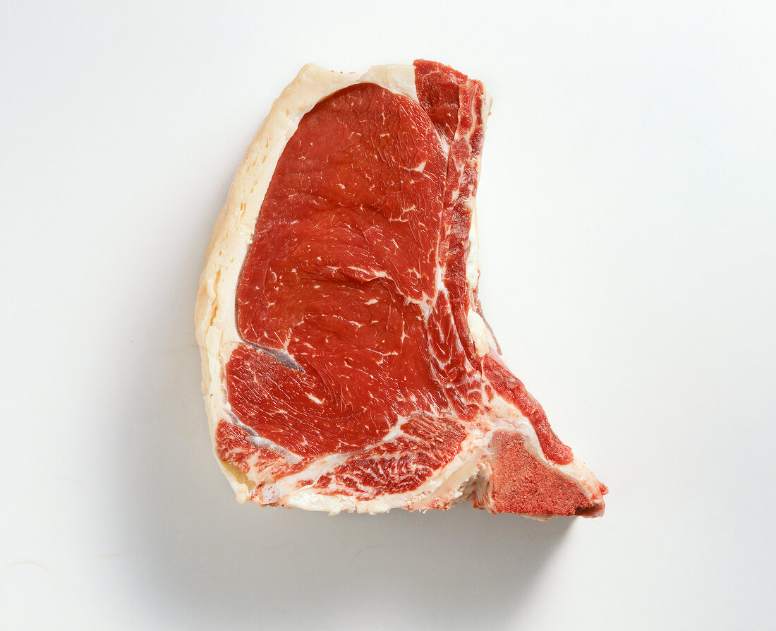 Close-up of raw beef steak on white background