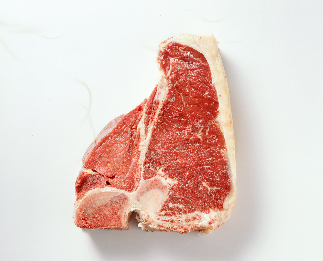Raw beef meat from T-bone steak on white background