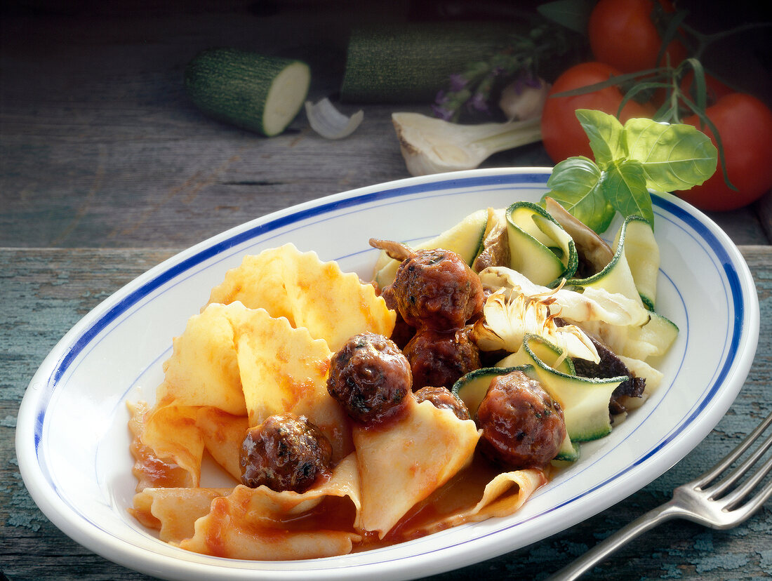 Beef polpettine with vegetables and pappardelle on plate