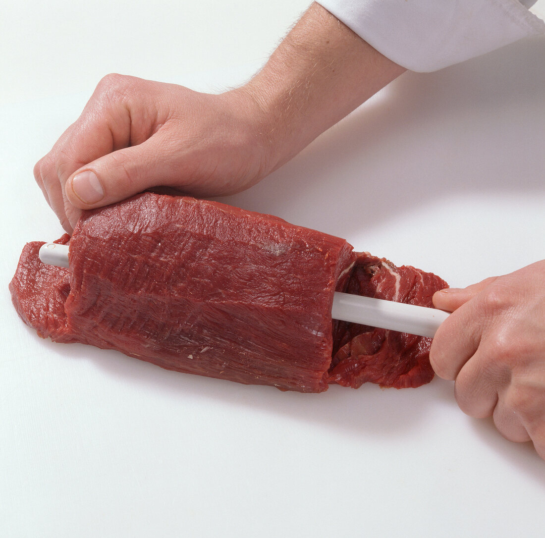 Close-up of inserting spoon in beef, step 1