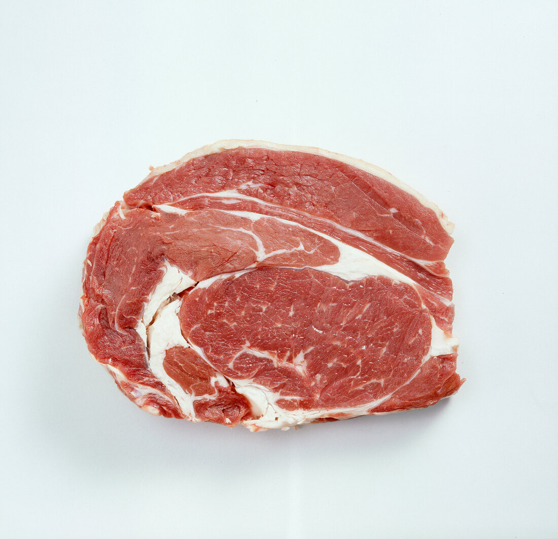 Piece of raw beef meat from high rib on white background