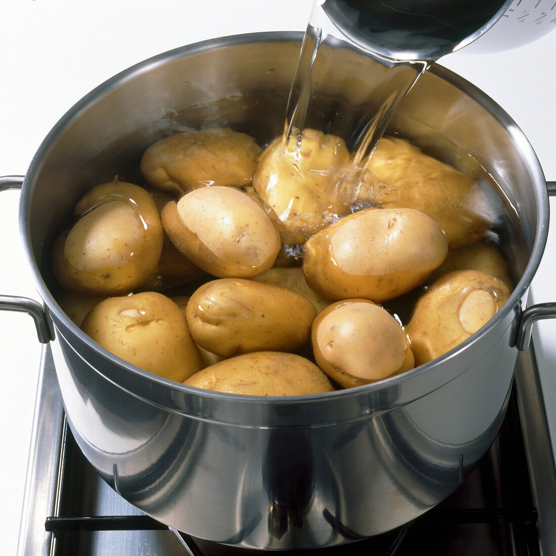 Close-up of adding water in potatoes, step 2