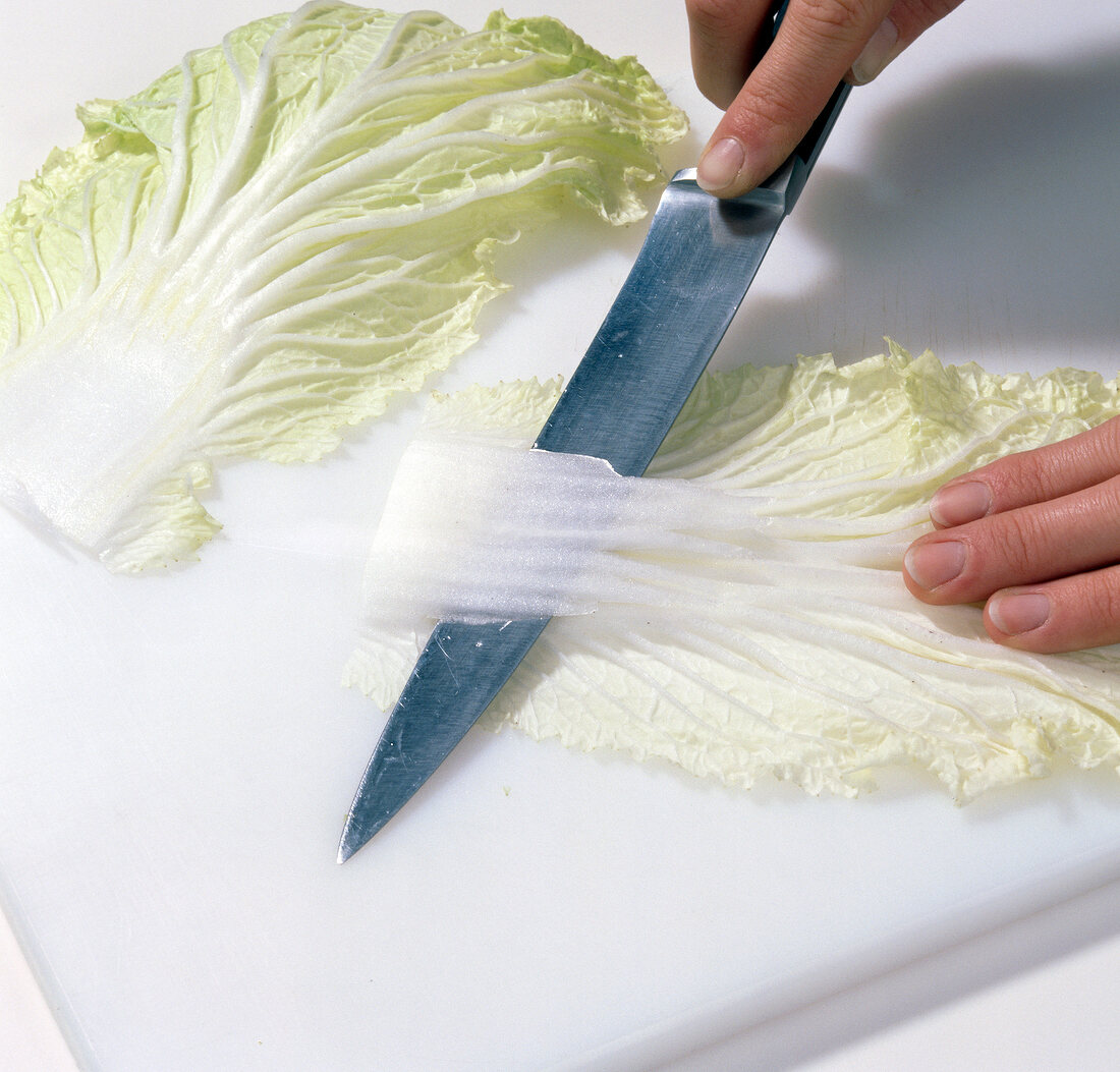 Chinese cabbage being cut with knife, step 1