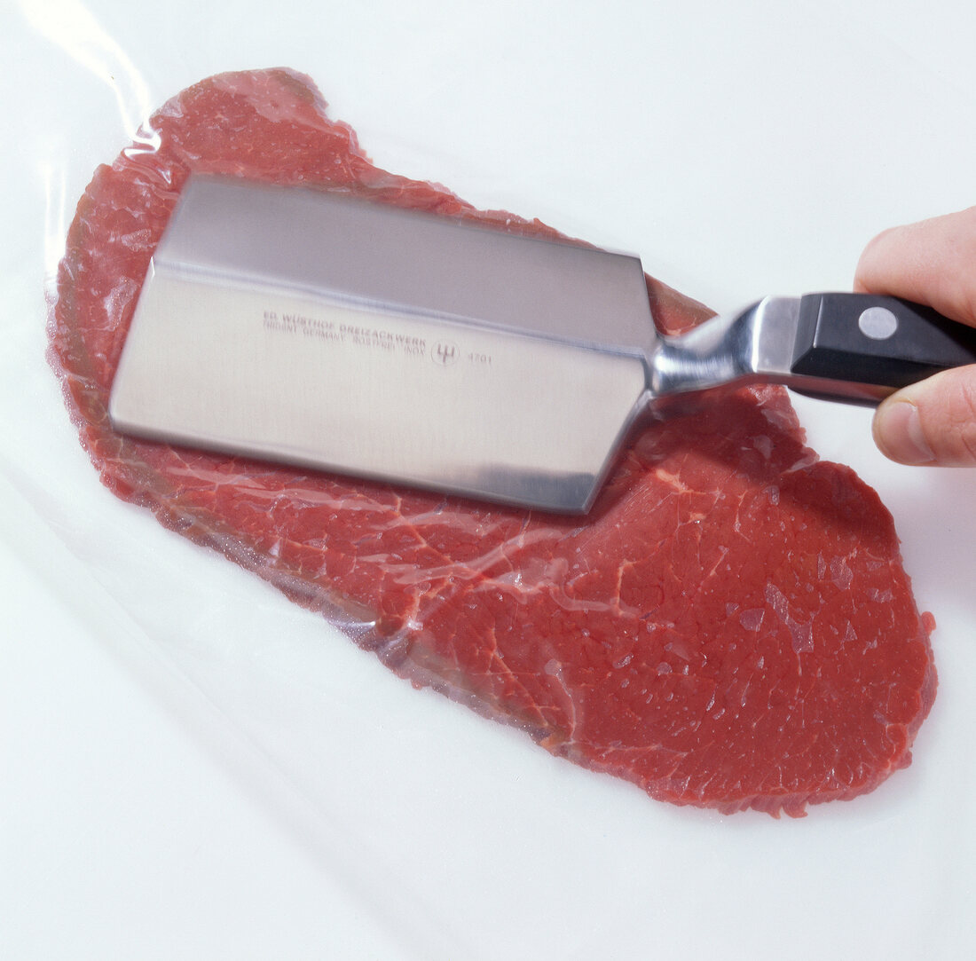 Flattening meat with meat flattener for preparation of beef tartare, step 2