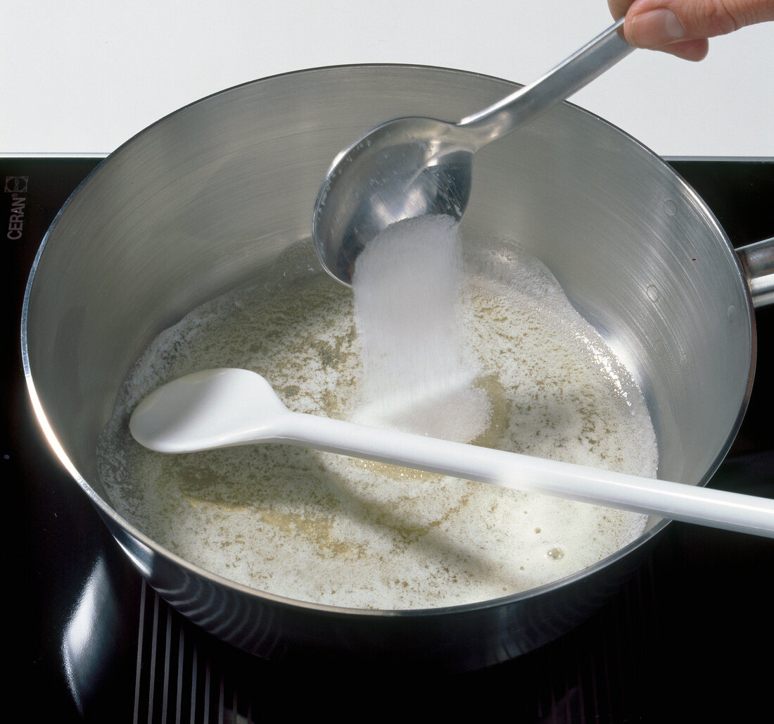 Adding sugar and salt to foam of butter in saucepan, step 1