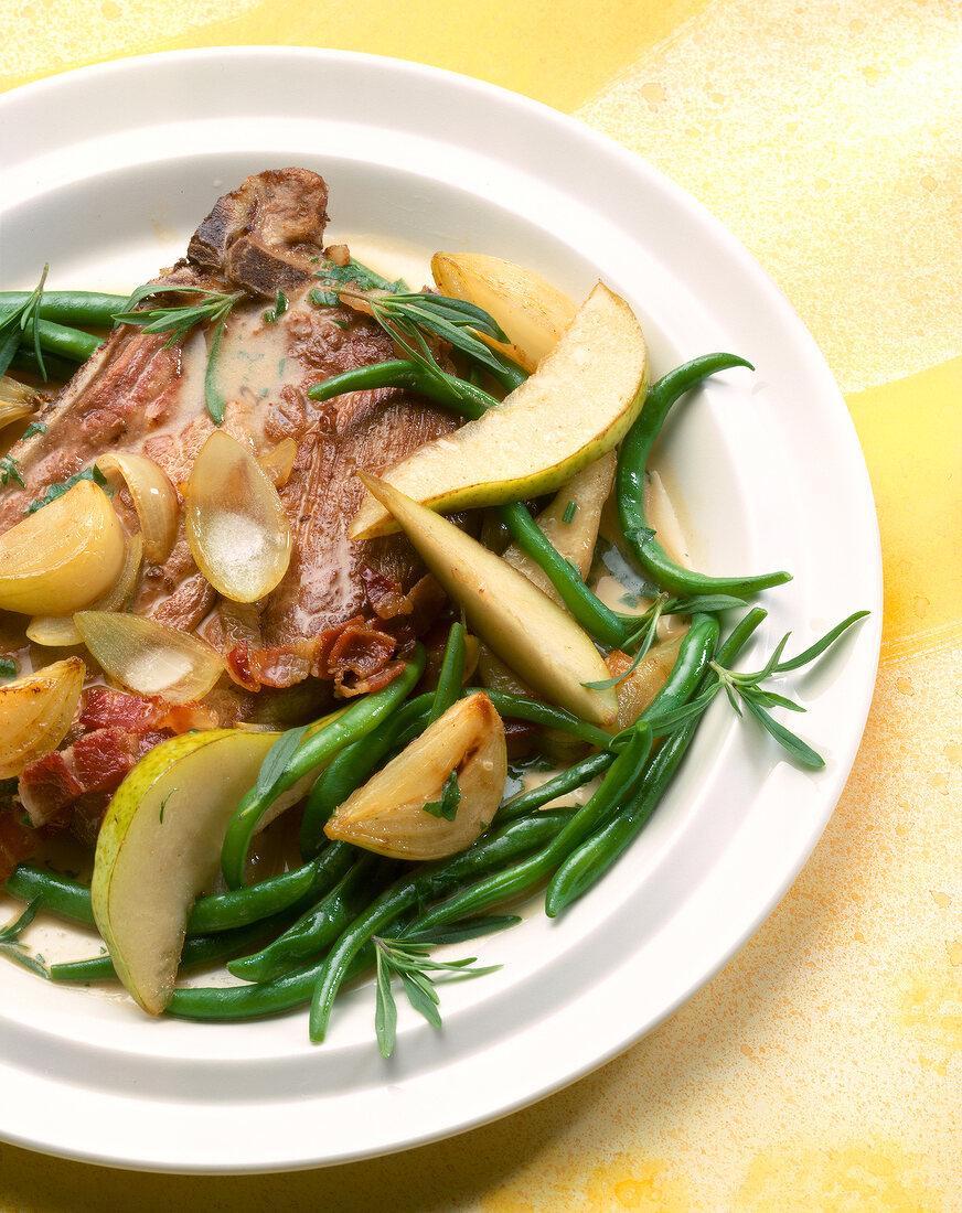 Close-up of chops with beans on plate