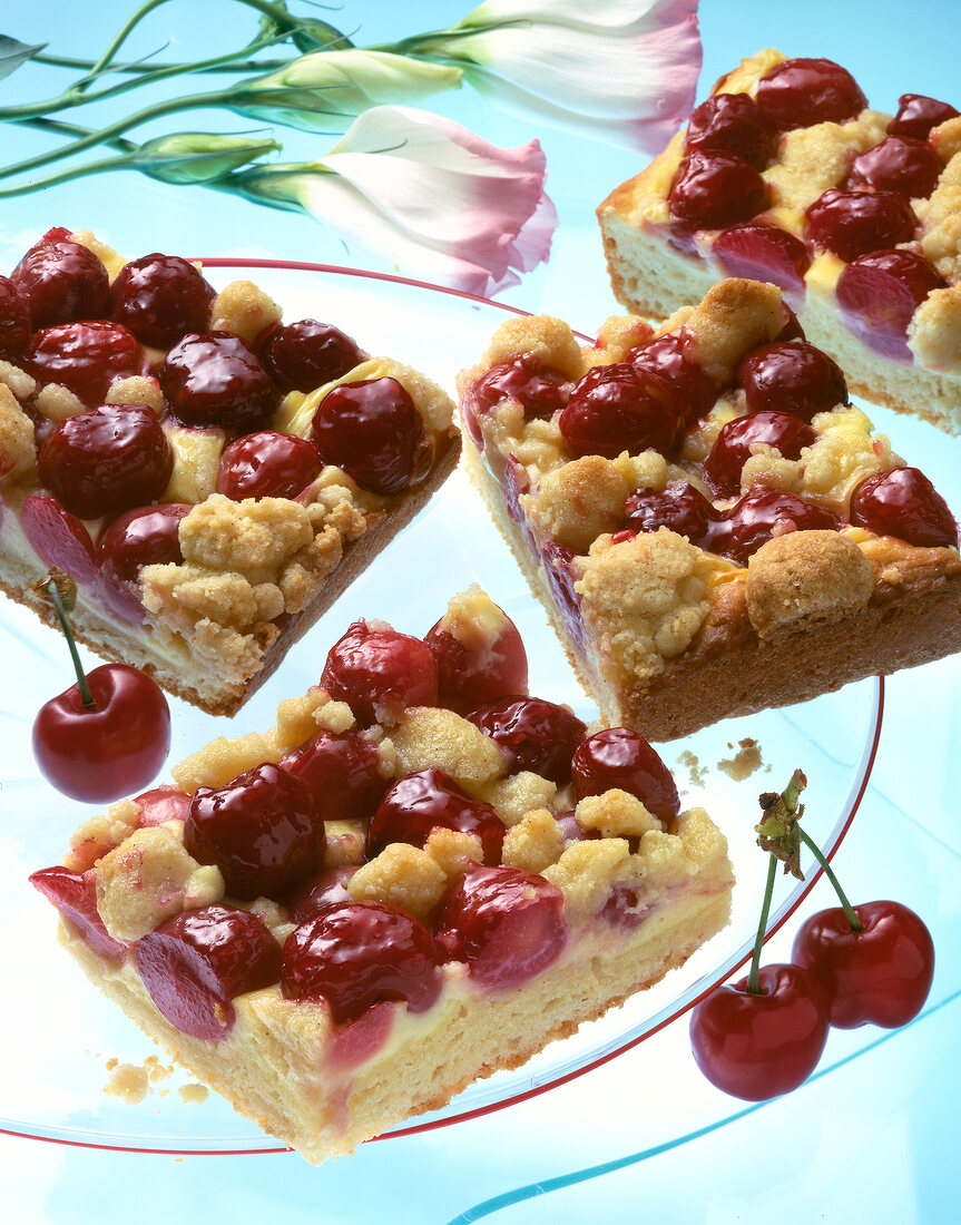 Close-up of crumble cake with cherries on plate