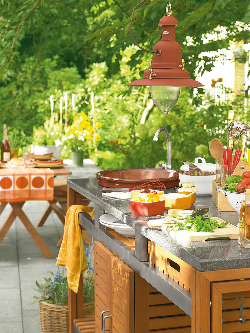 Outdoor kitchen counter made of stainless steel, granite and teak wood