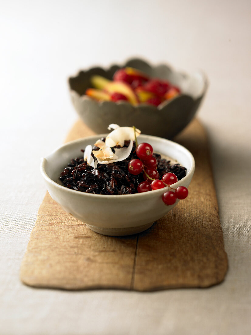 Black coconut rice with berries in bowl