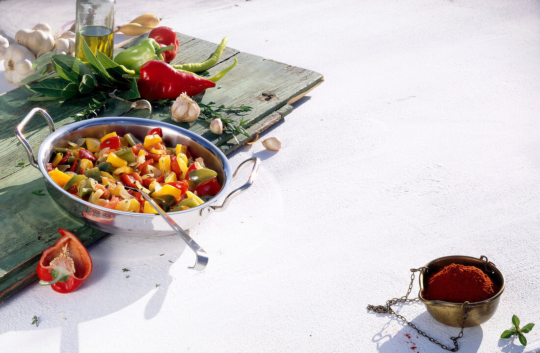 Seasoned peppers and vegetables in pan