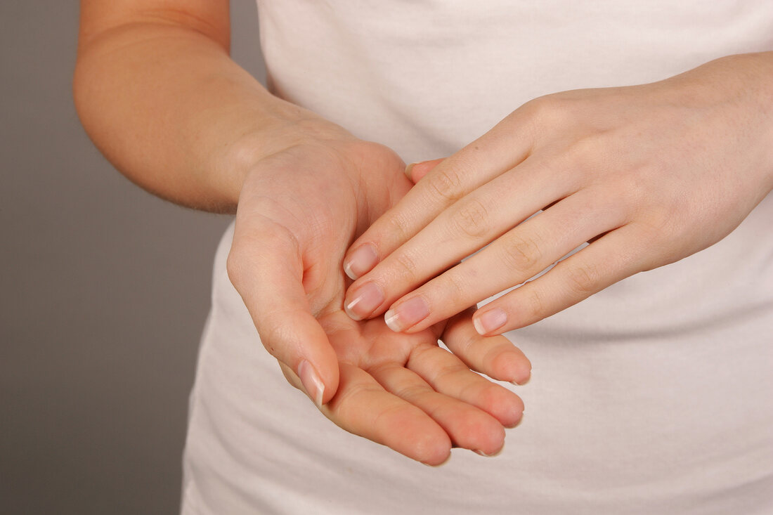 Close-up of woman applying lotion on her palms